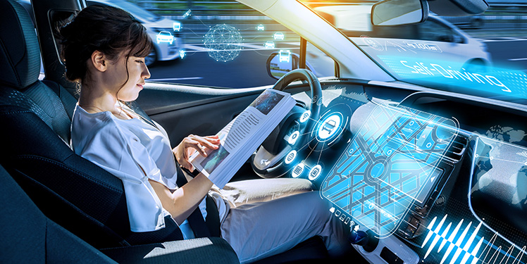 young woman reading a magazine in a autonomous car. driverless car. self-driving vehicle. heads up display. automotive technology.Fraunhofer-Institut IESE